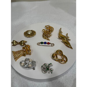 Bundle of 9 vintage Brooches Gold and Silver inc. bell music note bow Dolphin